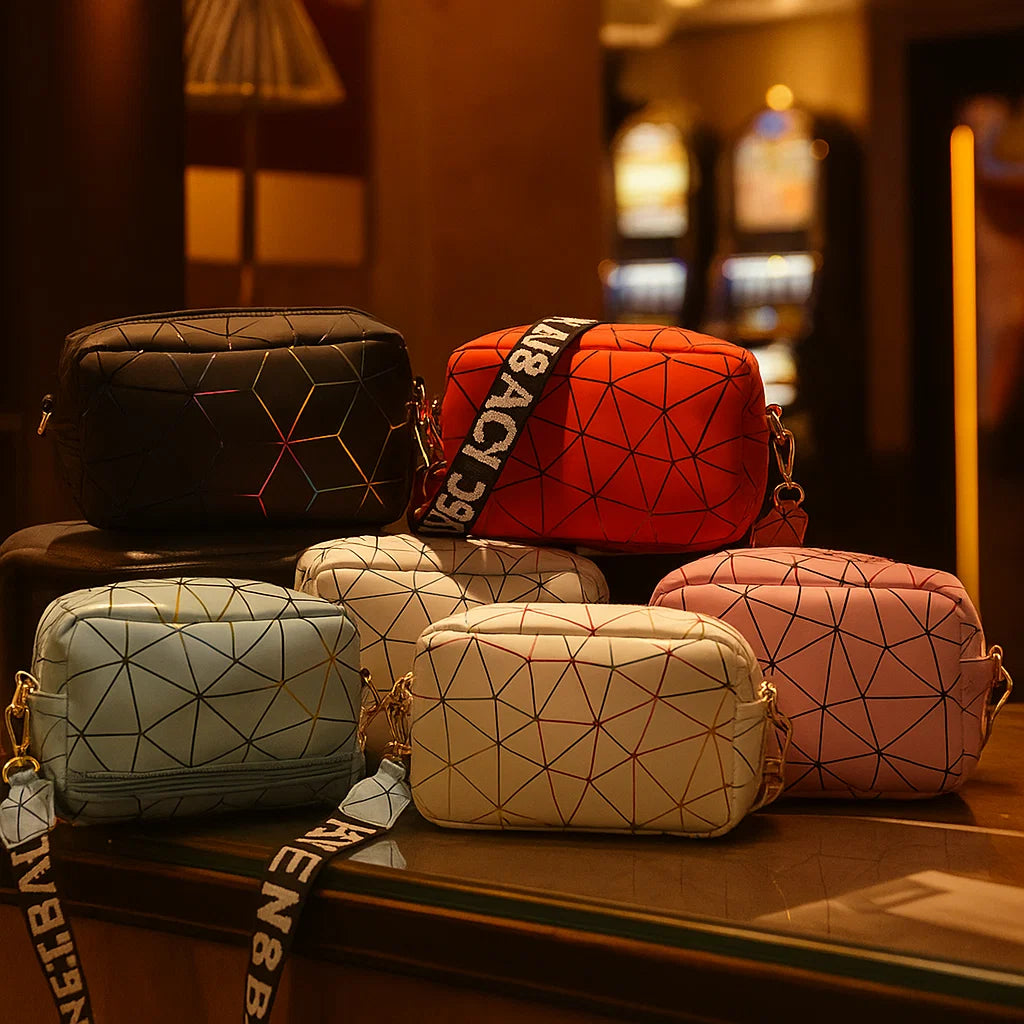 Geometric patterned handbags on a wooden surface with a blurred background