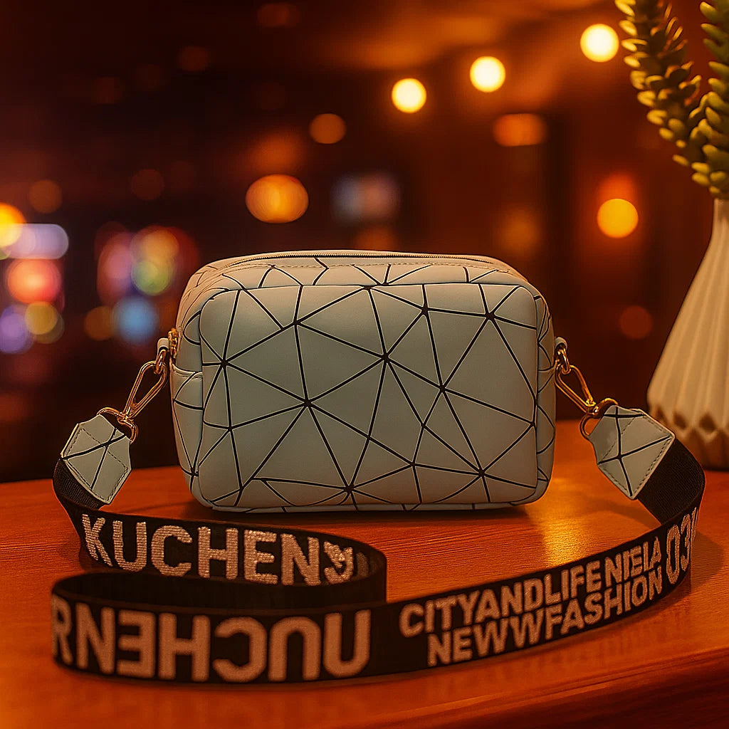 Geometric-patterned pouch with a strap on a wooden surface with blurred lights in the background