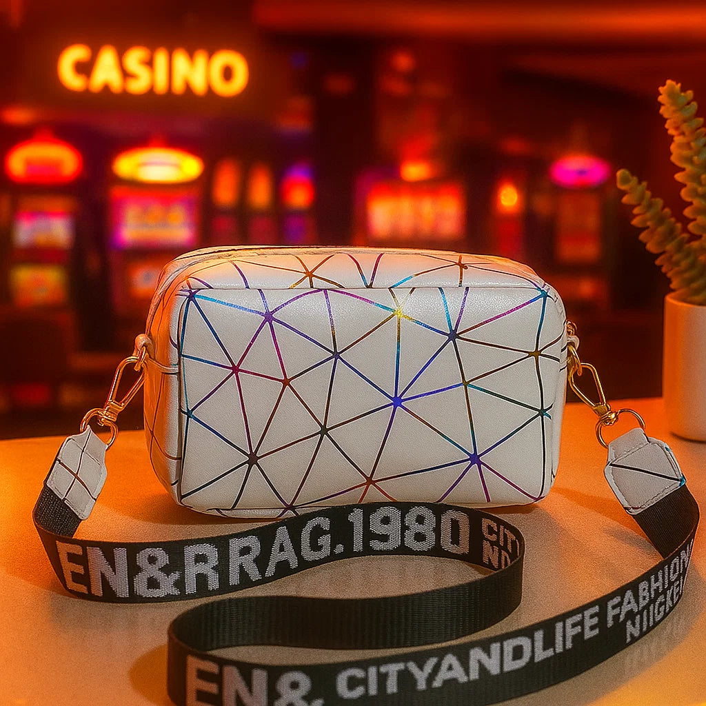 White geometric-patterned bag with colorful lines on a table in front of a casino setting.